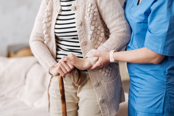 Care Home Nurse Helping Patient